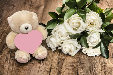 soft toy and bouquet of roses