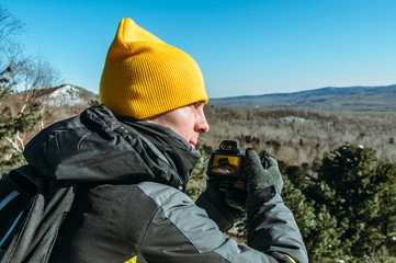 photographer naturalist at work in winter on top of the mountain