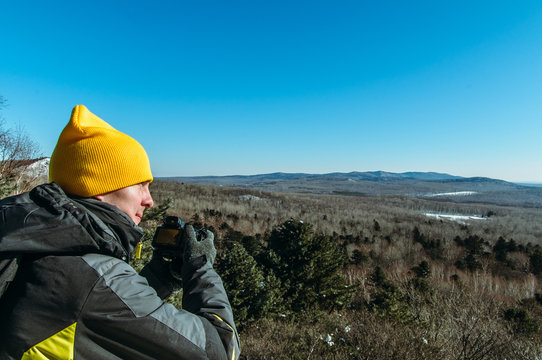 photographer naturalist at work in winter on top of the mountain