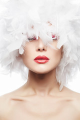 Beautiful Woman with red lips and white feathers
