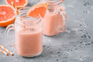 healthy detox smoothie in mason jar of red grapefruit with banana and chia seeds
