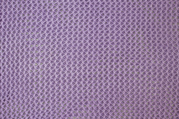 abstract knitted texture with holes of woolen fabric or textile cotton material of purple color