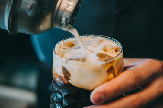 Alcohol Cocktail On The Bar. Bartender Making An Alcoholic Cocktail. Irish Cofee