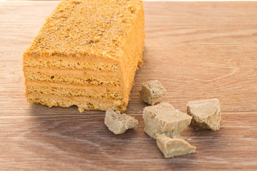 Traditional Russian baked honey cake on wooden table