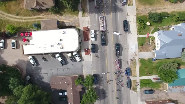 Aerial little kids bike parade in a small town. 
