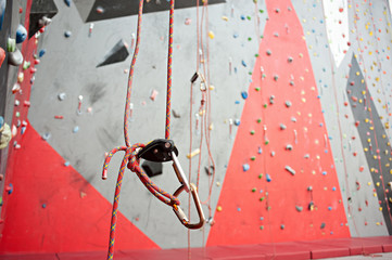 Climbing. A safety bolt threaded a rope with a carbine. Granite wall
