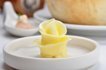Flower shaped butter on white plate     