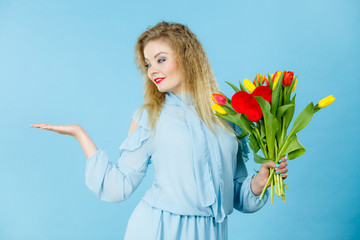 woman with tulips bunch, open hand