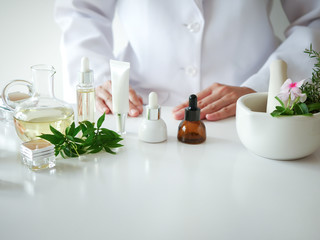 the scientist,dermatologist testing the organic natural  cosmetic product in the laboratory.research and development beauty skincare concept.blank package,bottle,container .cream,serum.hand