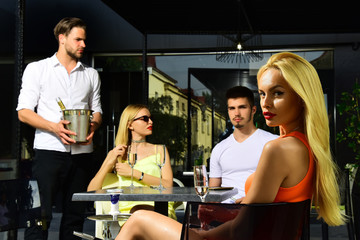 Friends drink champagne in cafe outdoor