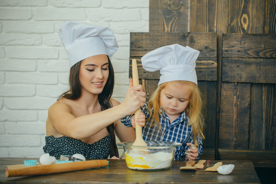 Mother and son mixing flour and eggs in bowl