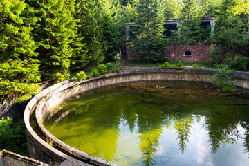 Concrete construction of ore floating tank at former tin mine Rolava and prison camp Sauersack near...