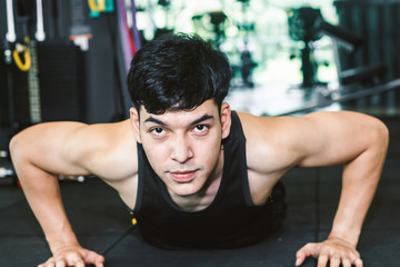 Man doing push ups exercise in fitness gym