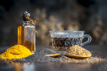 Brown mustard seeds,mustard seed's oil/Tea and crushed mustard seeds on the brown wooden...