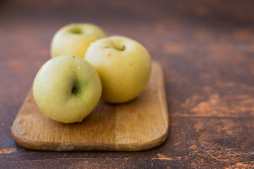 Fresh apples. Variety White pouring on a wooden cutting board