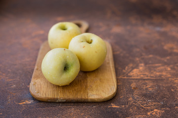 Fresh apples. Variety White pouring on a wooden cutting board