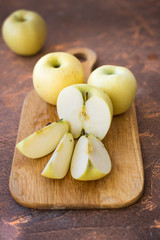 Fresh apples. Variety White pouring on a wooden cutting board