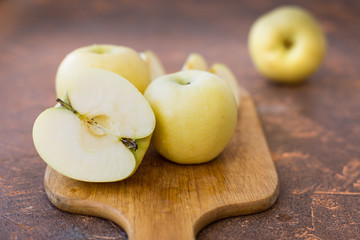 Fresh apples. Variety White pouring on a wooden cutting board