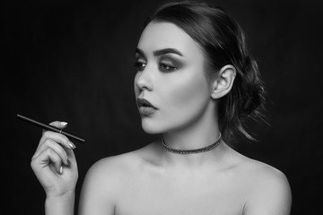 Fototapeta premium Glamour seductive gorgeous brunette woman smoking electronic cigarette