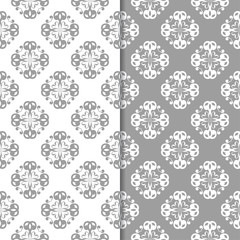 White and gray floral backgrounds. Set of seamless patterns