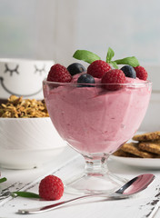 Healthy breakfast: Curd souffle with fresh blueberry, raspberries,multiseed biscuits, granola and tea