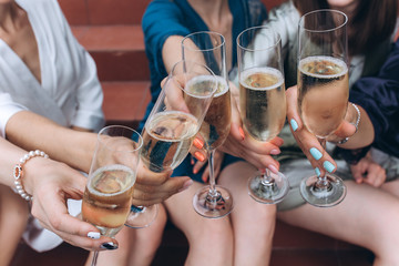 Guests congratulate the newlyweds with a glass of champagne in their hands.