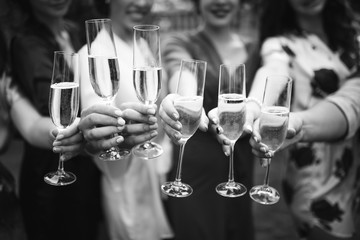 Guests congratulate the newlyweds with a glass of champagne in their hands.