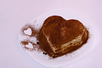 Tiramisu cake, cake tiramisu with berries. A cake of tiramisu sprinkled with berries in the form of a heart.