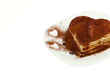 Tiramisu cake, cake tiramisu with berries. A cake of tiramisu sprinkled with berries in the form of a heart.