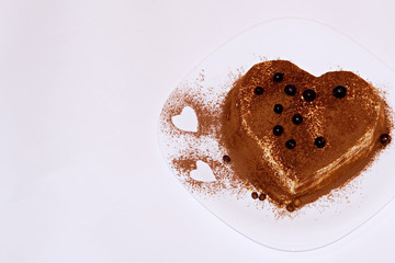 Tiramisu cake, cake tiramisu with berries. A cake of tiramisu sprinkled with berries in the form of a heart.