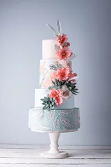Foto auf Acrylglas Wedding four-tiered cake decorated with spring red flowers and handmade pattern. Concept of delicious desserts © Artem