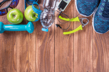 Set for sports activities on brown wooden background. Healthy lifestyle concept. Sport equipment,...