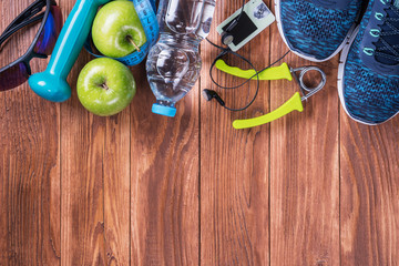 Set for sports activities on brown wooden background. Healthy lifestyle concept. Sport equipment,...