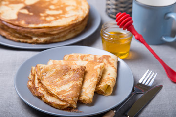 Traditional Russian pancakes with honey. Shrovetide. Maslenitsa week. Selective focus, close-up.