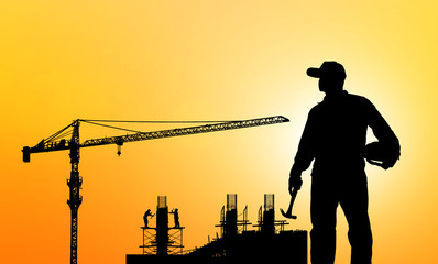 silhouette portrait of engineer Work order in construction site on blurry colorful light sunset