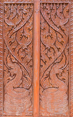 Carving pattern with the dragon symbol in the traditional Thai style.