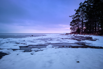 Ice and snow on a lake at sunset