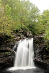 Fototapeta na wymiar A waterfall in Scotland near Loch Lomond