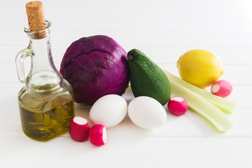 Colored foodstuff vegetables eggs white wooden table top view.