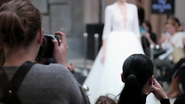 the photographer takes photos of the models at the fashion show