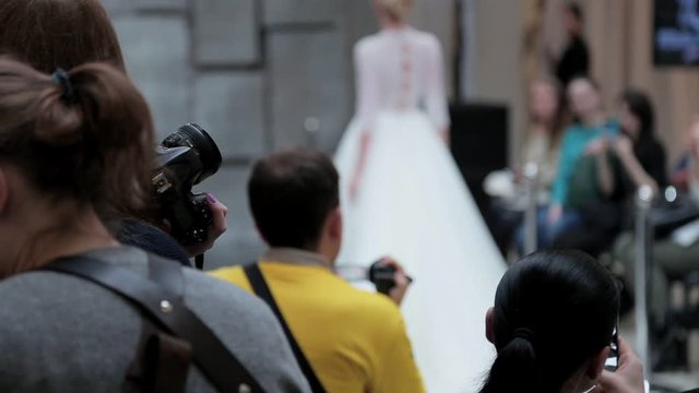 the photographer takes photos of the models at the fashion show
