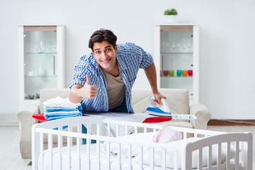 Young dad looking after newborn baby