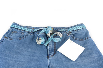 Blue jeans with measure tape with paper note. Exercise and diet concept