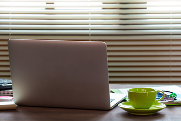 Business Technologies. Workplace with open laptop on modern wooden desk.