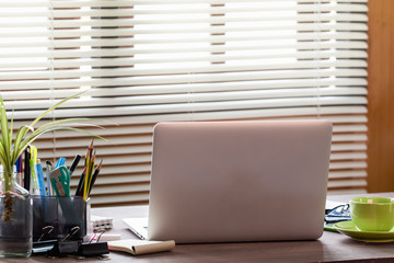 Business Technologies. Workplace with open laptop on modern wooden desk.