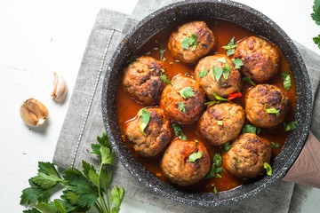 Meatballs in tomato sauce in a frying pan top view. 
