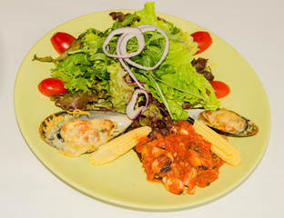mussels with cheese and stewed vegetables on a white background