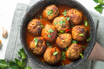 Meat balls in tomato sauce in a frying pan top view. 