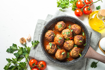 Meat balls in tomato sauce in a frying pan top view. 