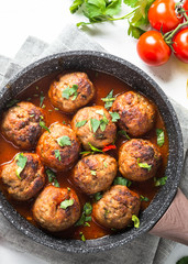 Meatballs in tomato sauce in a frying pan. 
